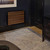 REL Planar PL-2 – 8” Powered Subwoofer on wall installation black living room with woodgrille