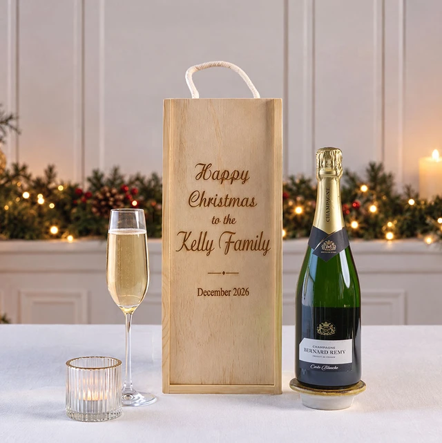 Happy Christmas Champagne in Personalised Wooden Box gift set featuring premium champagne presented in a personalised engraved wooden keepsake box, beautifully displayed with a champagne flute and festive Christmas decorations, making it a thoughtful holiday gift.