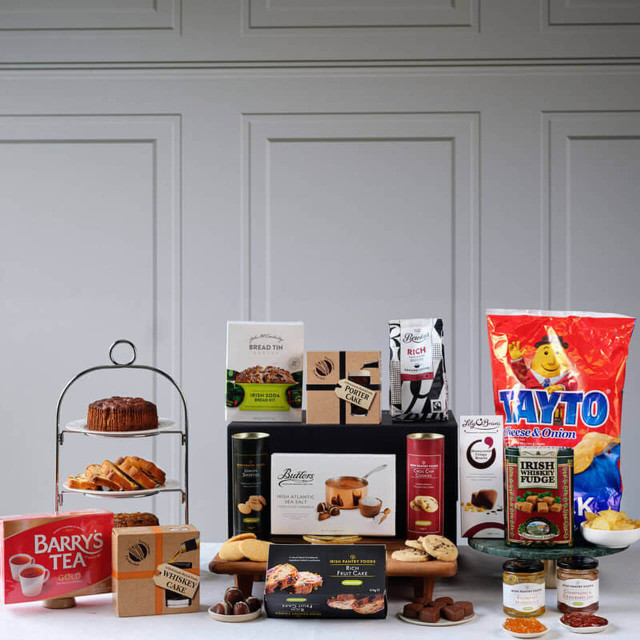 Traditional Irish Feast Hamper featuring Tayto cheese and onion crisps, Barry’s Tea, Christmas pudding, mince pies, Irish soda bread mix, rich fruit cake, gourmet chocolates, and festive treats beautifully arranged  – available at GiftsDirect.com