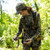 Malta Hunting Hunter's Elite Tree Stand Harness Kit - hunter fastening the quick connect leg buckle