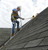 Roofer using a Ridge Pro on a shingle roof.