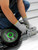 Frontline RO2W two-way standing seam anchor being installed on a metal roof by a worker