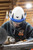 Malta Dynamics ALM flashlight system in use, HAZ-LO light mounted to a safety helmet face shield for hands-free illumination