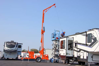 Malta X1240 mobile grabber deployed at a jobsite with the boom extended to a 30 ft overhead anchor point