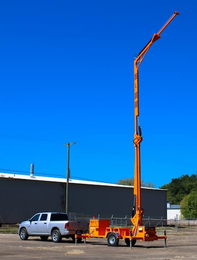 Malta X1270 mobile grabber with the boom fully extended to a 45 ft overhead anchor against a blue sky
