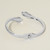 Sleek Sculpted Stainless Steel Sculpted Wrap Hinged Bangle Bracelet - Rhodium
