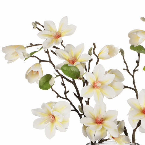 Detailed view of white real touch magnolia blossoms with soft yellow centers and green leaves, showcasing realistic petals and branching stems.