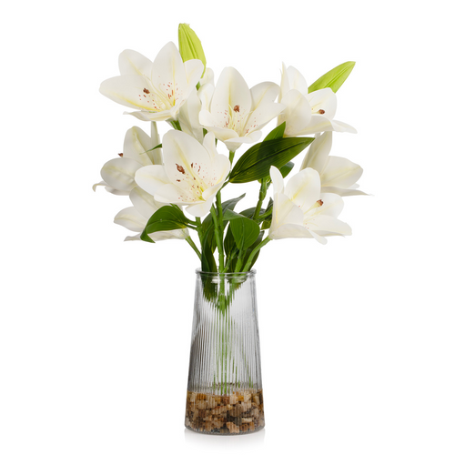 Faux tiger lily centerpiece displayed on a living room coffee table, featuring real touch white lilies in a clear glass vase with decorative stones.