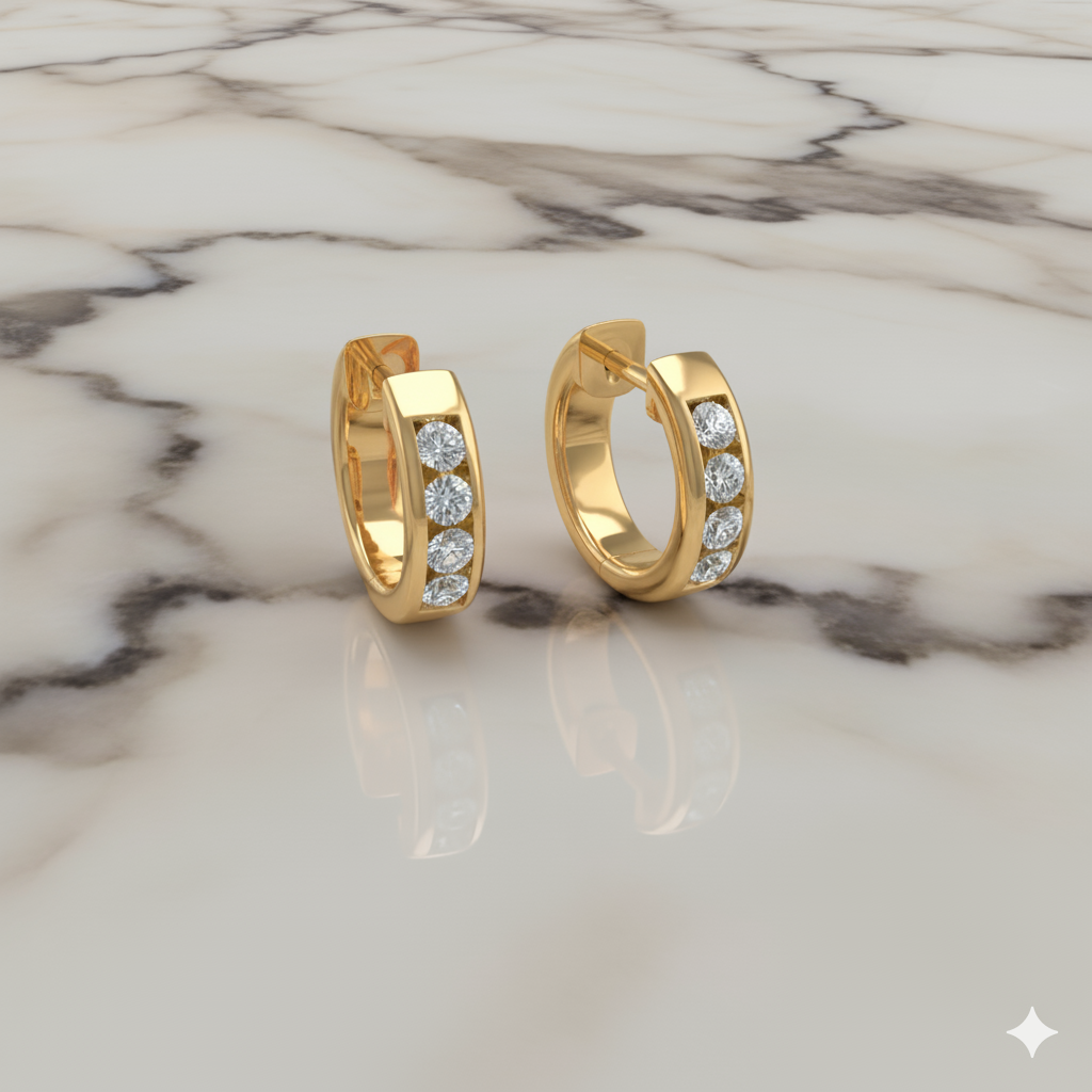 An angled view of a pair of 14K yellow gold huggie hoops, showcasing the three-stone cluster on a marble background.