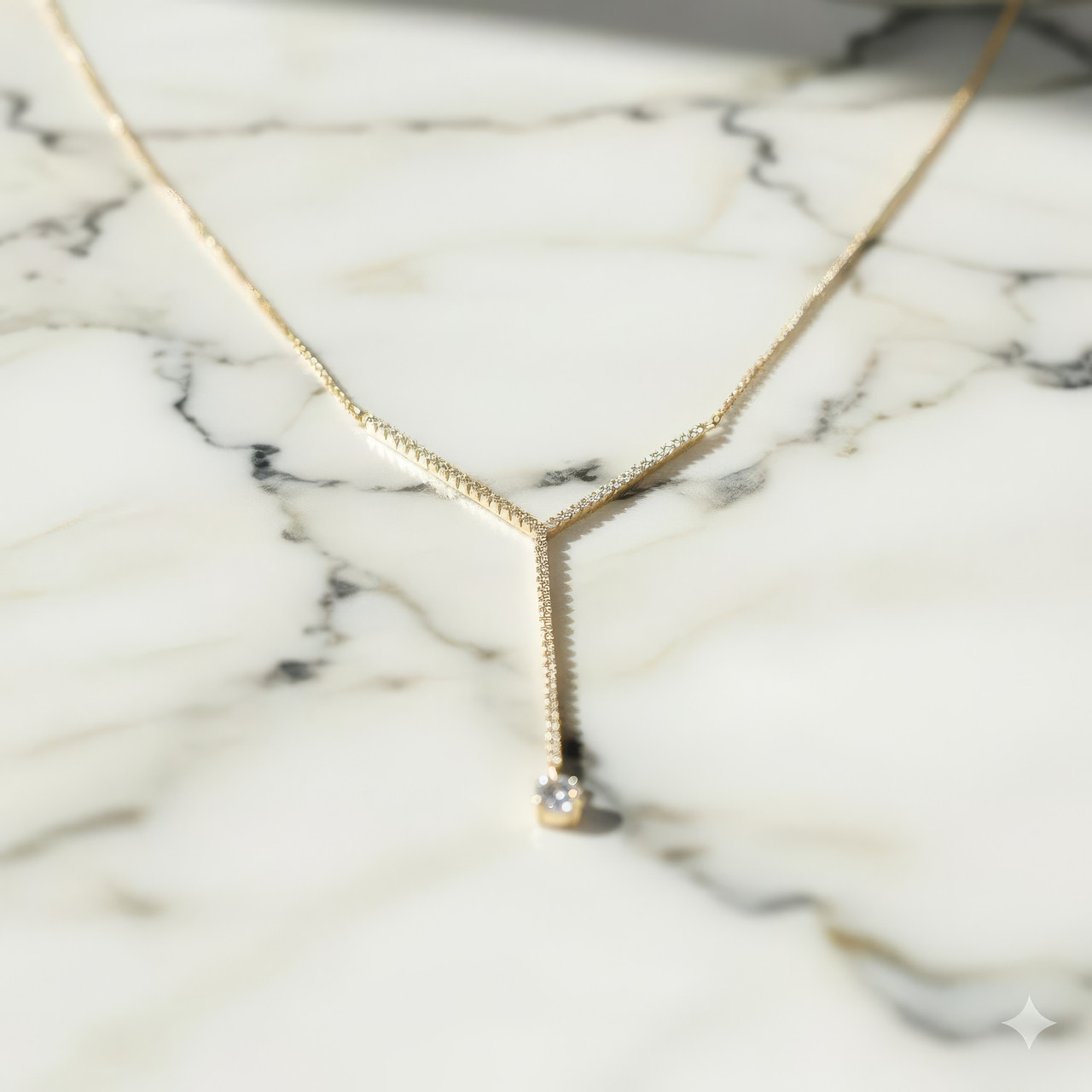 White gold diamond Y-necklace styled on white marble, emphasizing contrast, delicate sparkle, and modern elegance.