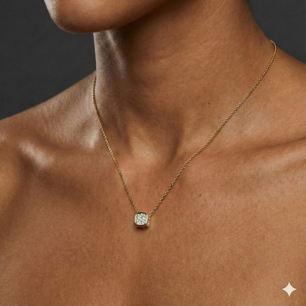 Yellow gold cushion cluster diamond necklace worn on figure, offering a warm glow and timeless everyday elegance.