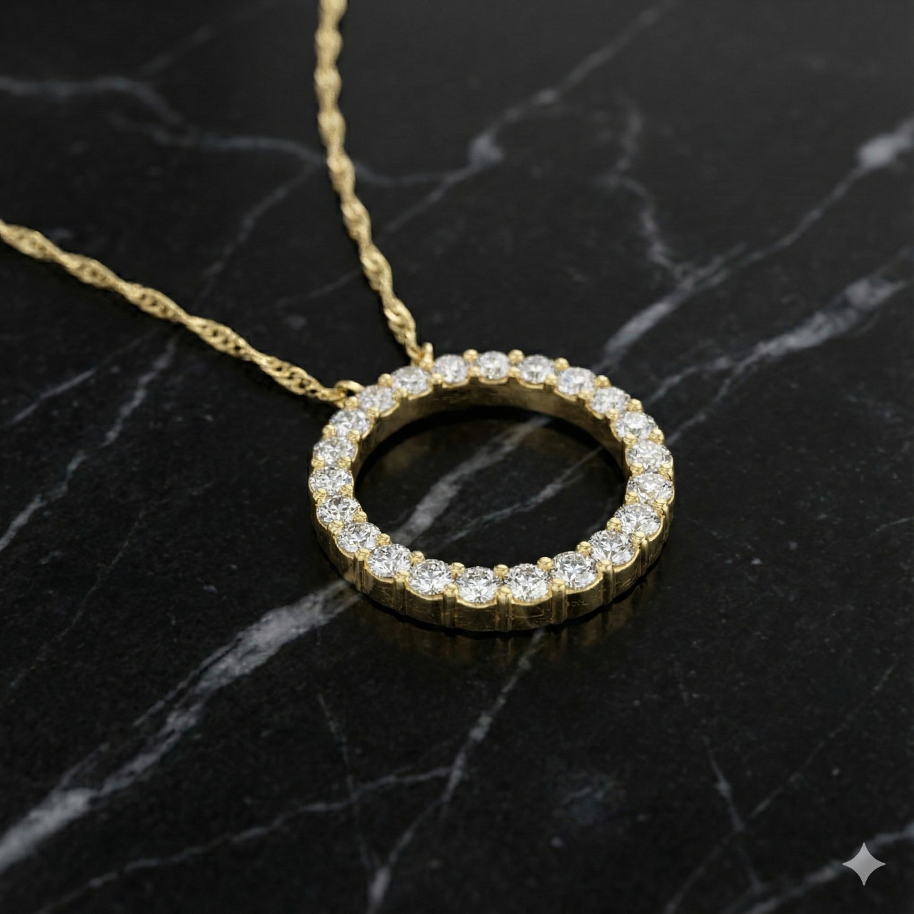 Angled view of a yellow gold circle pendant necklace featuring pavé white diamonds resting on a black marble surface.