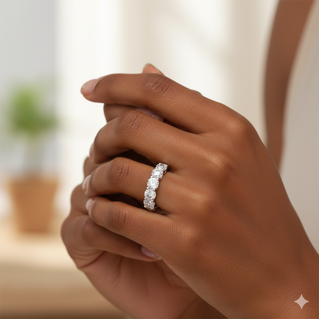 An angled view of a 14K white gold ring, showcasing the brilliant arrangement of the five round gems please put this on a finger.