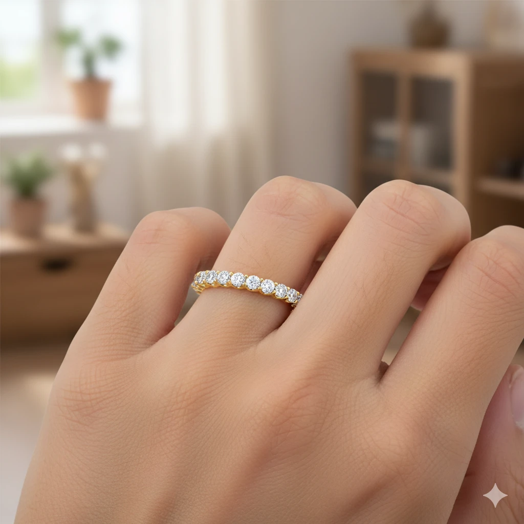 Amorati Diamonds, Infinity Loop Full Eternity Ring, an angled view on-hand of a 10K white gold eternity band, showcasing the brilliant row of round jewels on a hand.