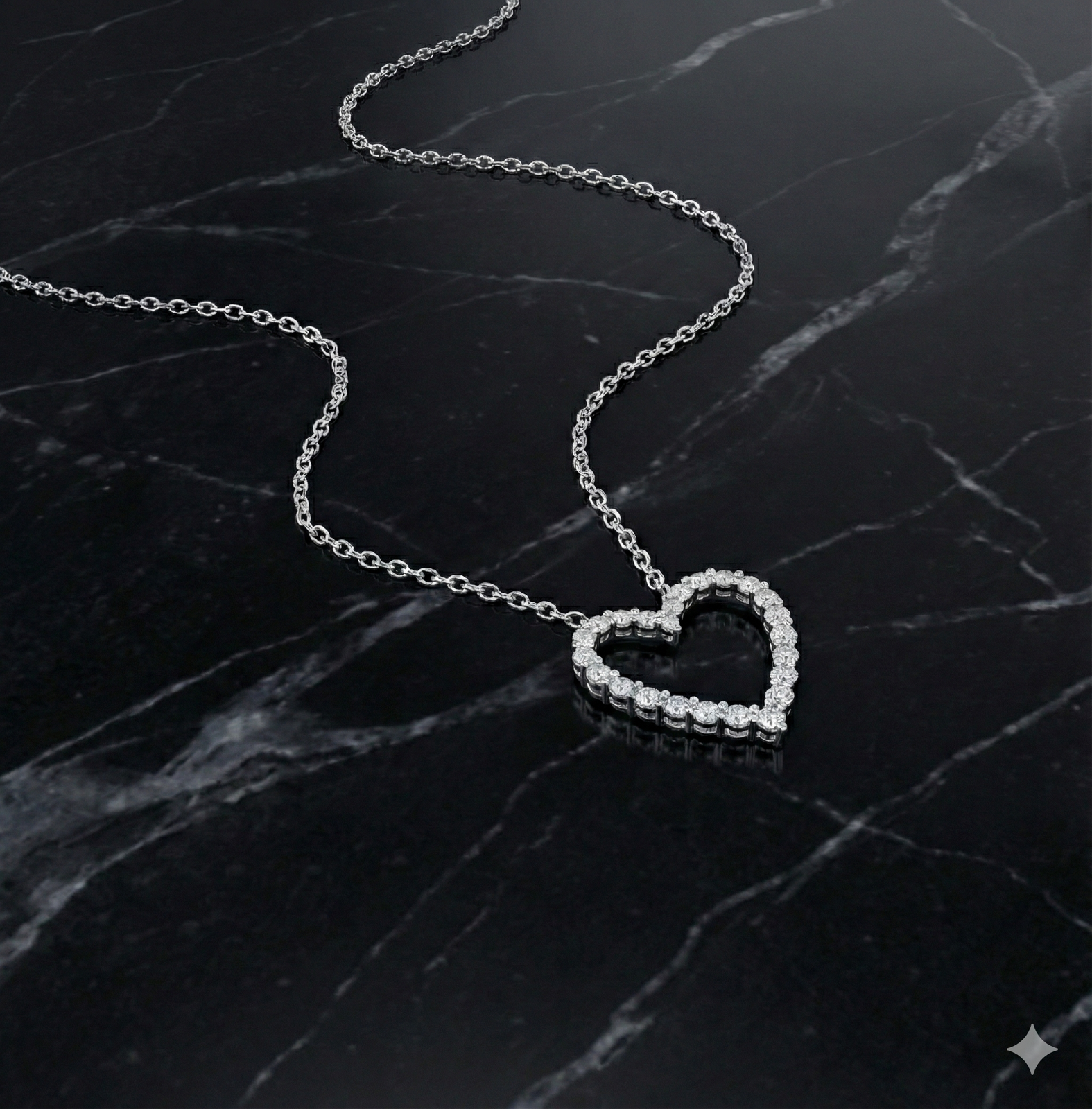 White gold petite diamond heart pendant necklace styled on black marble, emphasizing refined scale, contrast, and delicate brilliance.
