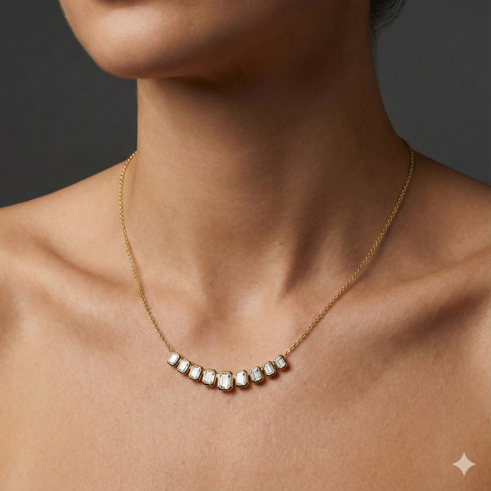 Yellow gold smaller emerald-cut diamond necklace worn on figure, offering a warm glow and effortlessly minimal sophistication.