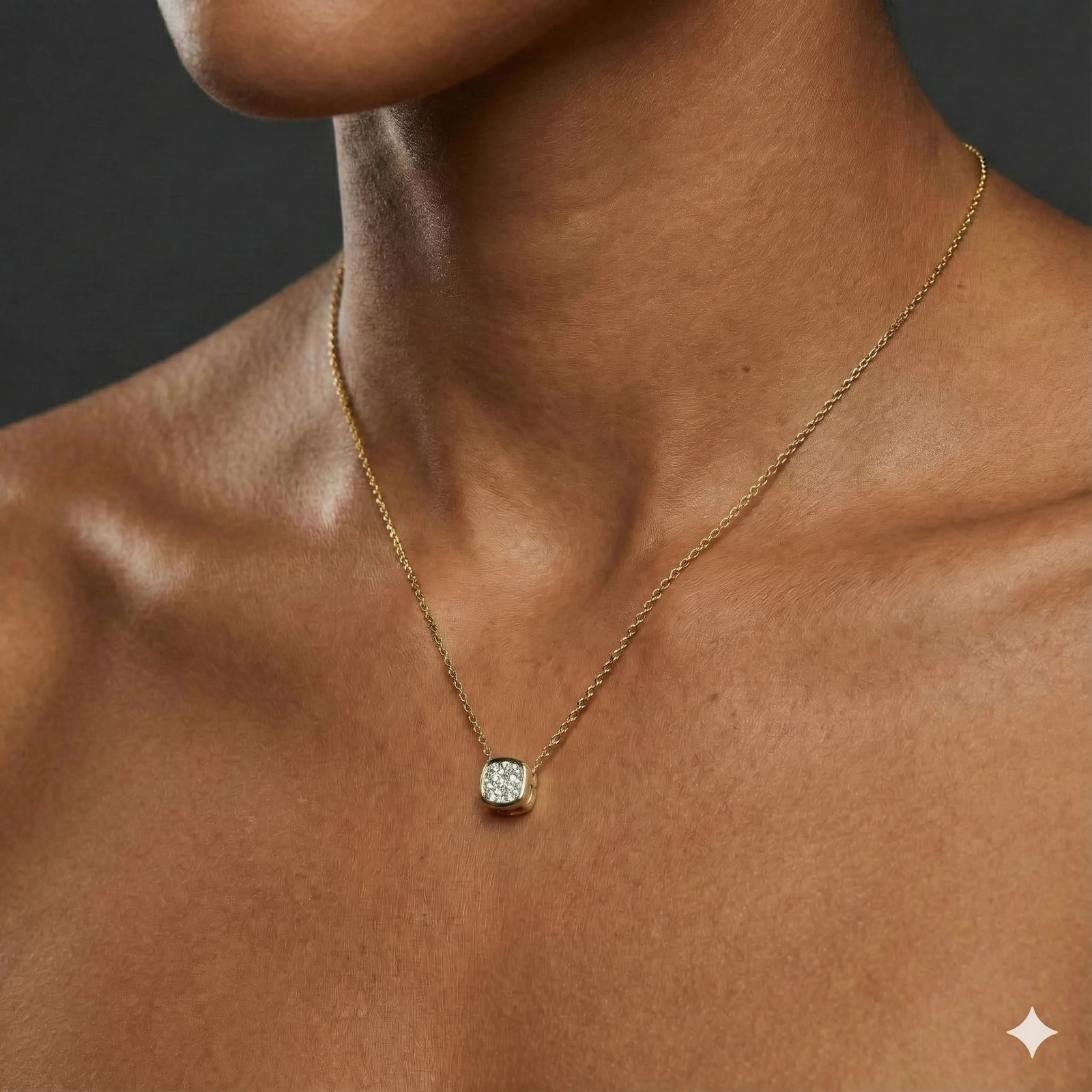 Yellow gold cushion cluster diamond necklace worn on figure, offering a warm glow and timeless everyday elegance.