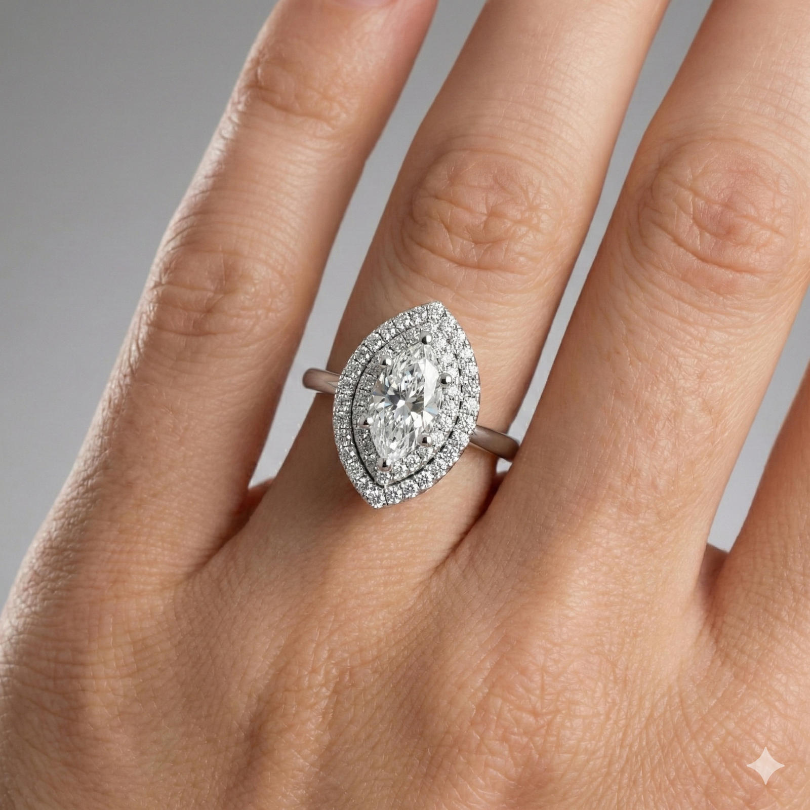 Marquise cut diamond engagement ring in 14k white gold with a plain band and solitaire setting on a hand