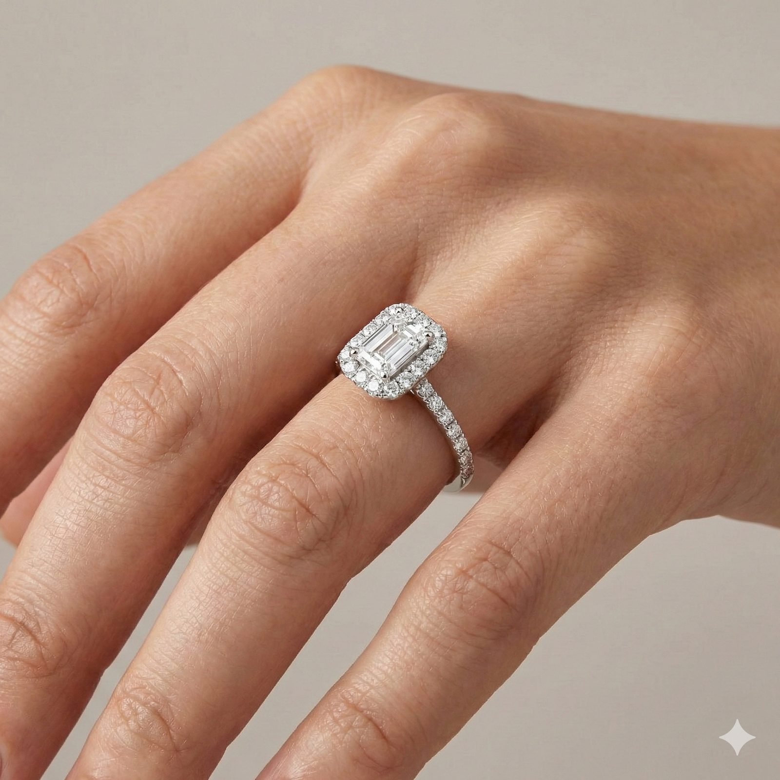 Emerald cut diamond engagement ring in 14k white gold with a prong diamond band and cathedral setting on a hand
