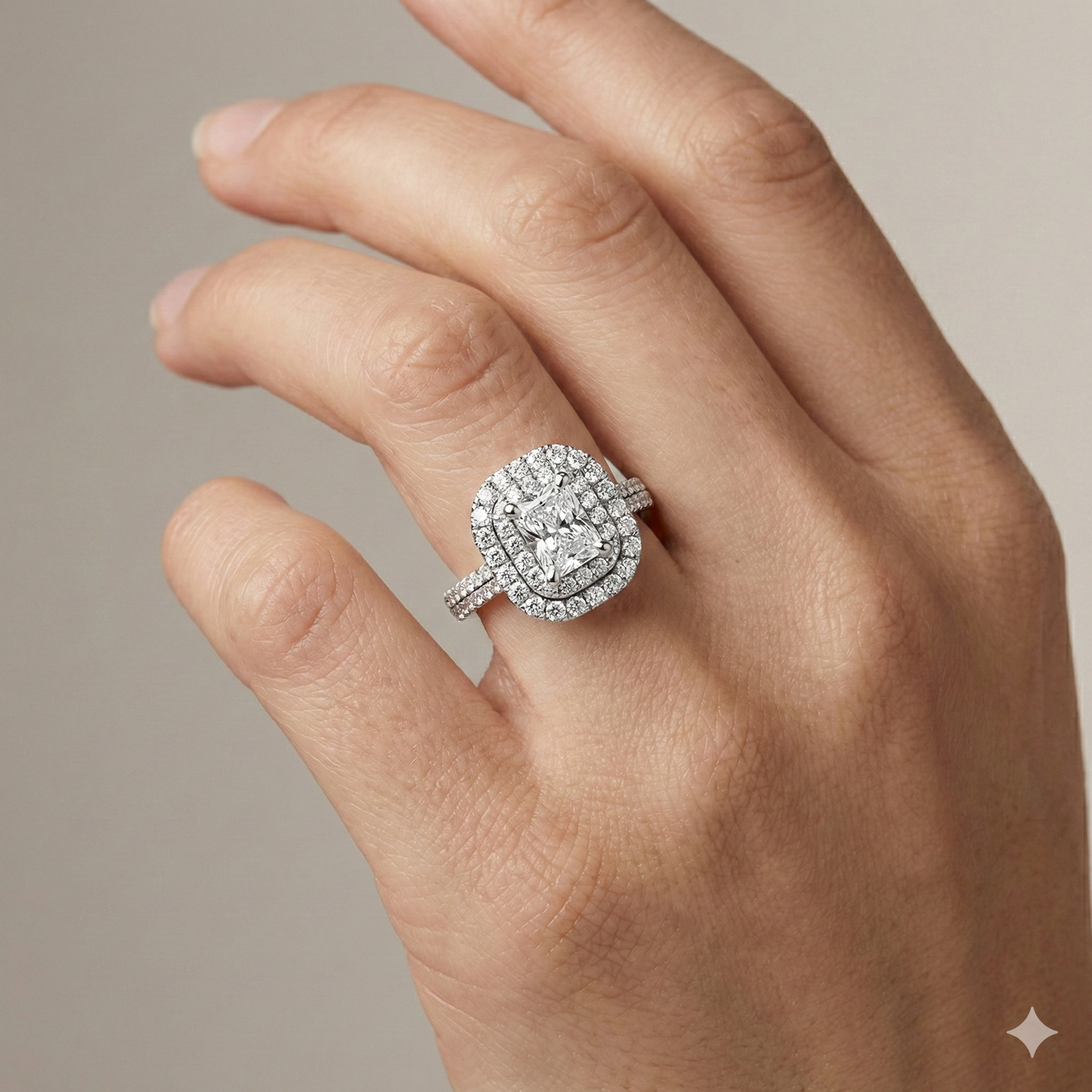 Radiant cut diamond engagement ring in 14k white gold with a pavé diamond band and solitaire setting on a hand
