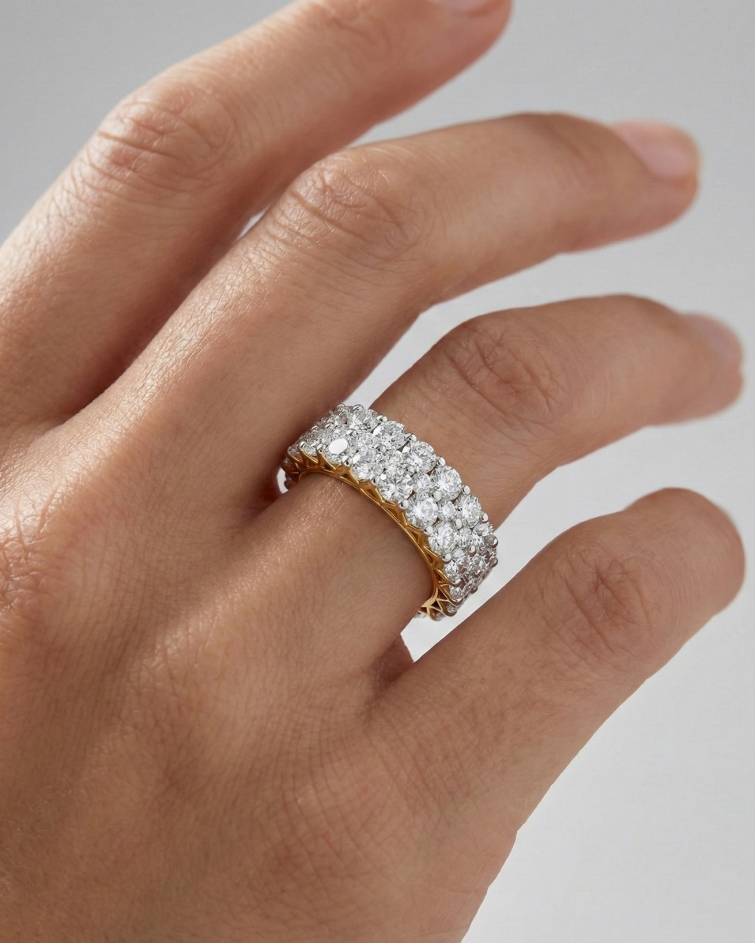 A breathtaking 14k yellow gold full eternity band featuring two rows of shimmering round-cut lab-grown diamonds totaling 3.0 carats on hand.