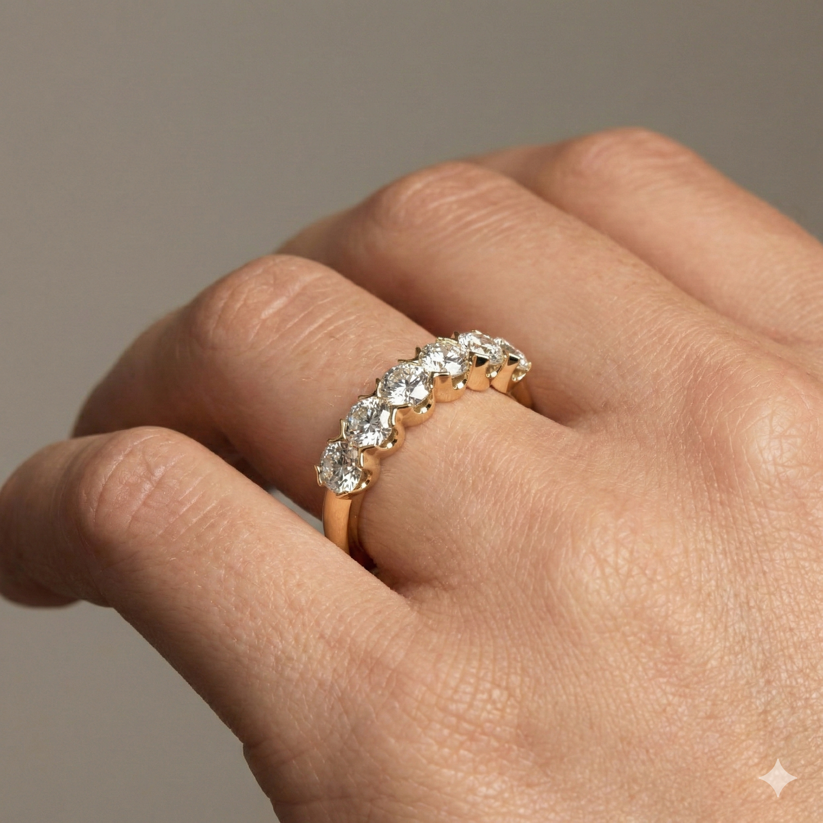 A classic 14k yellow gold wedding band featuring 1.0 total carat of radiant round-cut lab-grown diamonds on hand.