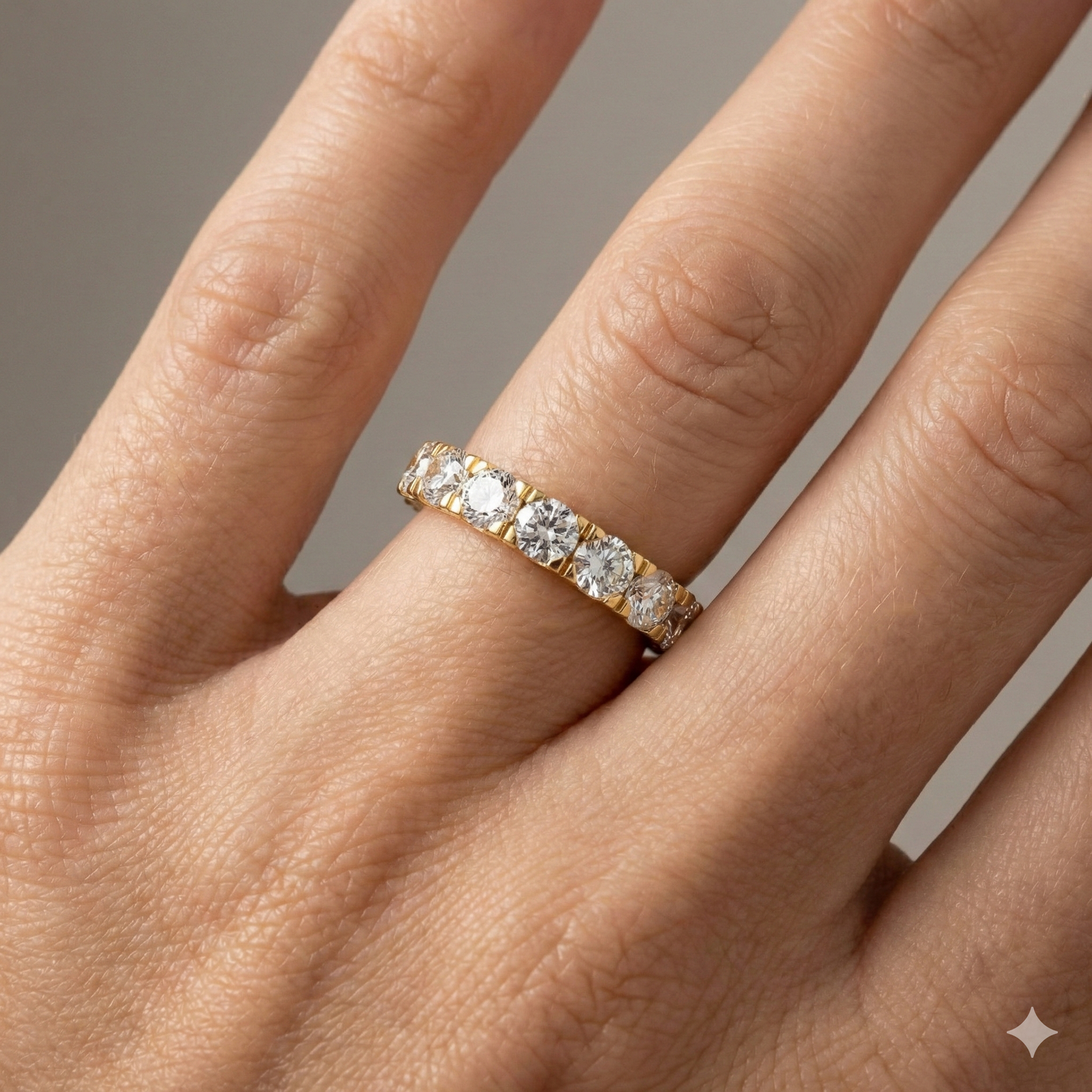 A magnificent 14k yellow gold eternity band featuring a continuous circle of 4.0 total carats of brilliant round-cut lab-grown diamonds on hand.