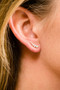 A pair of 14K white gold ear climber stud earrings with a line of graduated pavé diamonds, shown on a model.