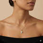 Yellow gold round solitaire diamond necklace worn on figure, offering a warm glow and effortless everyday sophistication.