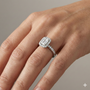 Radiant cut diamond engagement ring in 14k white gold with a diamond channel band and cathedral setting on a hand