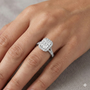 Radiant cut diamond engagement ring in 14k white gold with a diamond channel band and split setting on a hand
