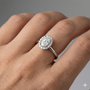 Oval cut diamond engagement ring in 14k white gold with a plain band and solitaire setting on a hand