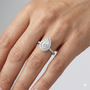 Pear cut diamond engagement ring in 14k white gold with a pavé diamond band and solitaire setting on a hand