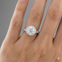 Round cut diamond engagement ring in 14k white gold with a diamond channel band and split setting on a hand
