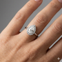 Pear cut diamond engagement ring in 14k white gold with a plain band and solitaire setting on a hand