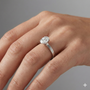 Oval cut diamond engagement ring in 14k white gold with a plain band and solitaire setting on a hand