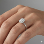Radiant cut diamond engagement ring in 14k white gold with a plain band and solitaire setting on a hand