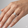 Pear cut diamond engagement ring in 14k white gold with a plain band and solitaire setting on a hand