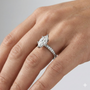 Marquise cut diamond engagement ring in 14k white gold with a diamond channel band and cathedral setting on a hand