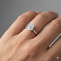 Oval cut diamond engagement ring in 14k white gold with a plain band and solitaire setting on a hand