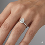 Pear cut diamond engagement ring in 14k white gold with a plain band and solitaire setting on a hand