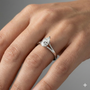 Pear cut diamond engagement ring in 14k white gold with a plain band and split setting on a hand