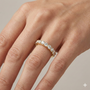 A sophisticated 14k yellow gold wedding band featuring 0.75 total carats of round-cut lab-grown diamonds in a classic half eternity setting on hand.