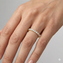 A delicate 14k yellow gold wedding band featuring 0.33 total carats of round-cut lab-grown diamonds in a classic half eternity setting on hand.