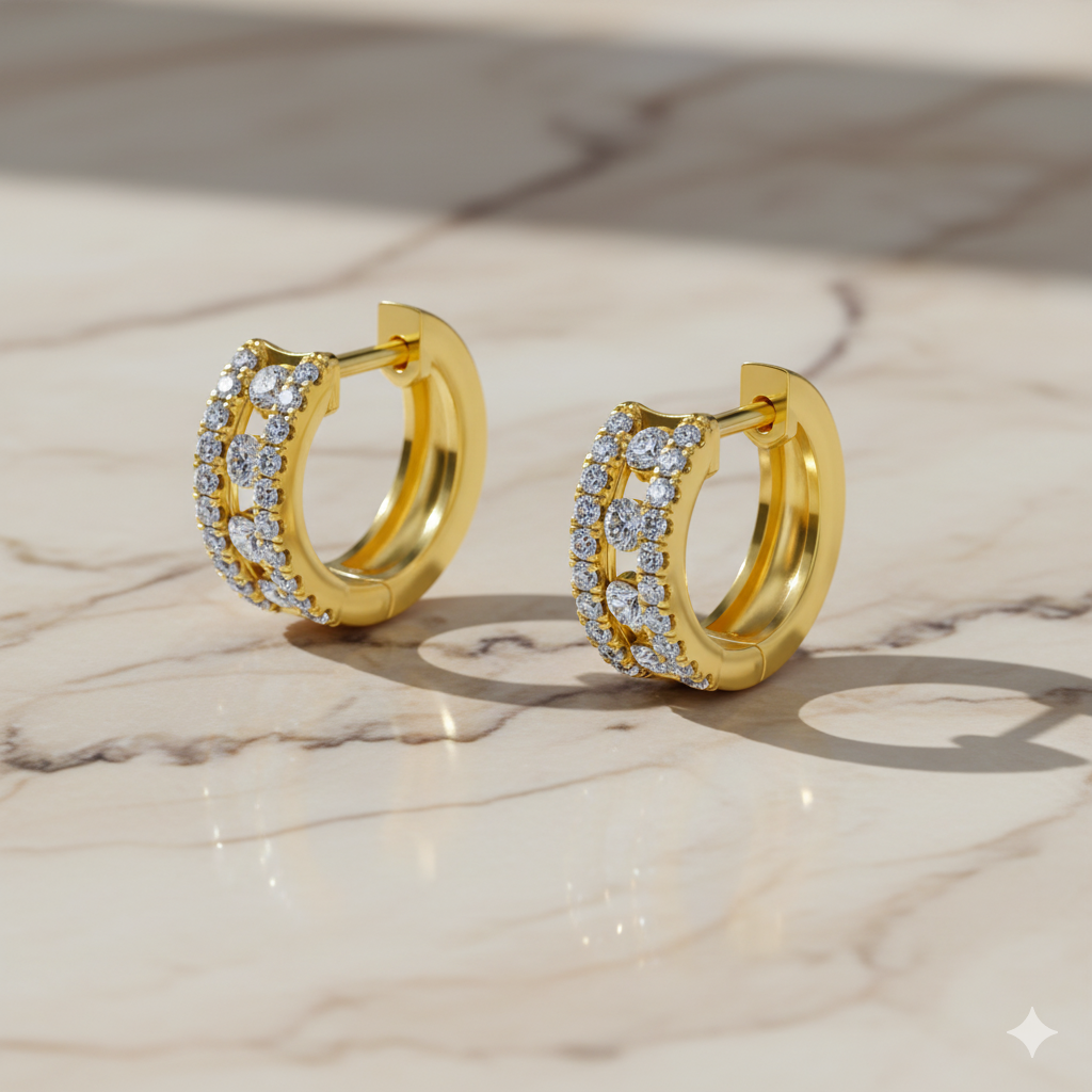 A side-angled view of a pair of 14K yellow gold huggie hoops, showing the two rows of diamonds and the hinged closure on a marble background.