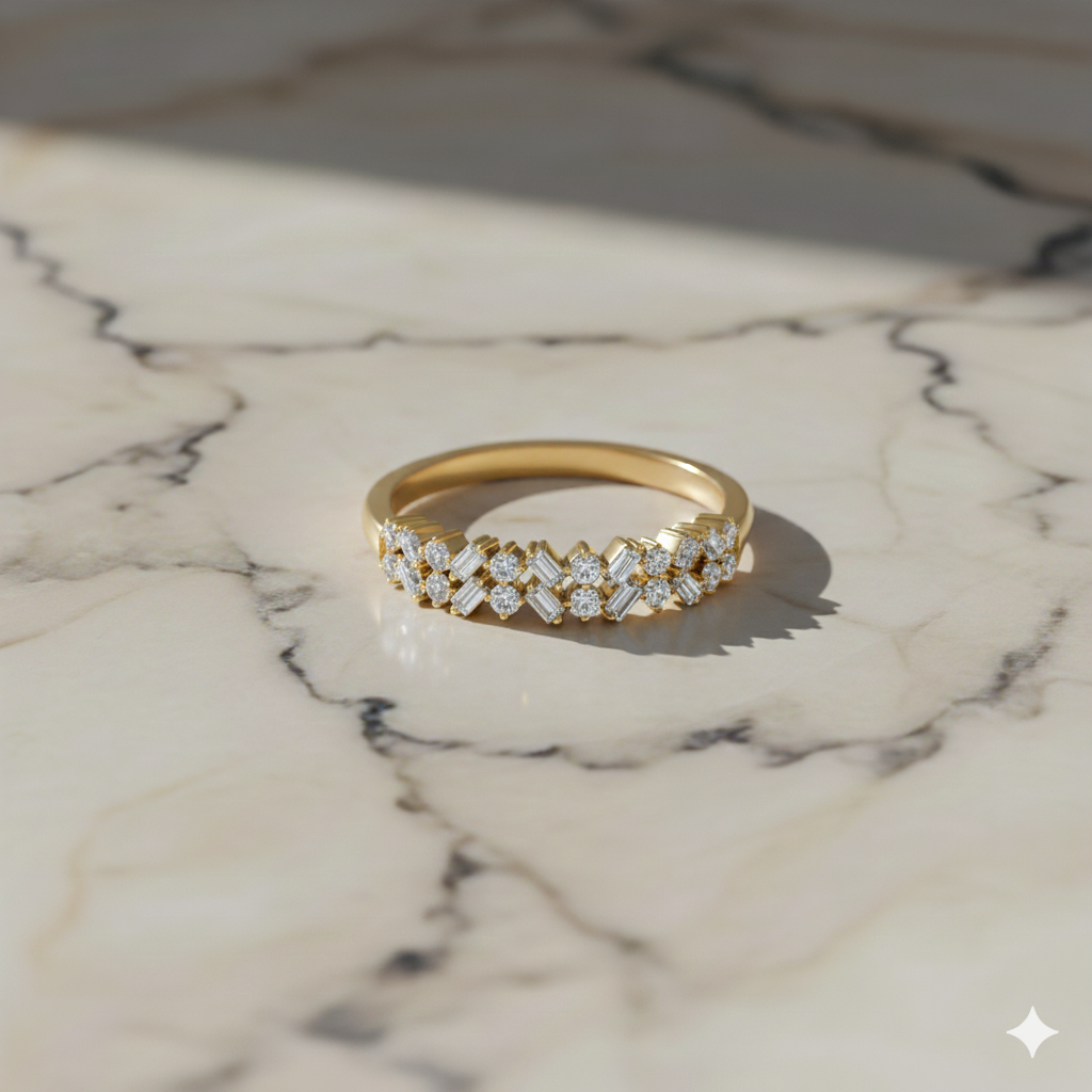 A top-down view of a 14K yellow gold eternity band with a continuous row of alternating baguette and round jewels on a marble background.