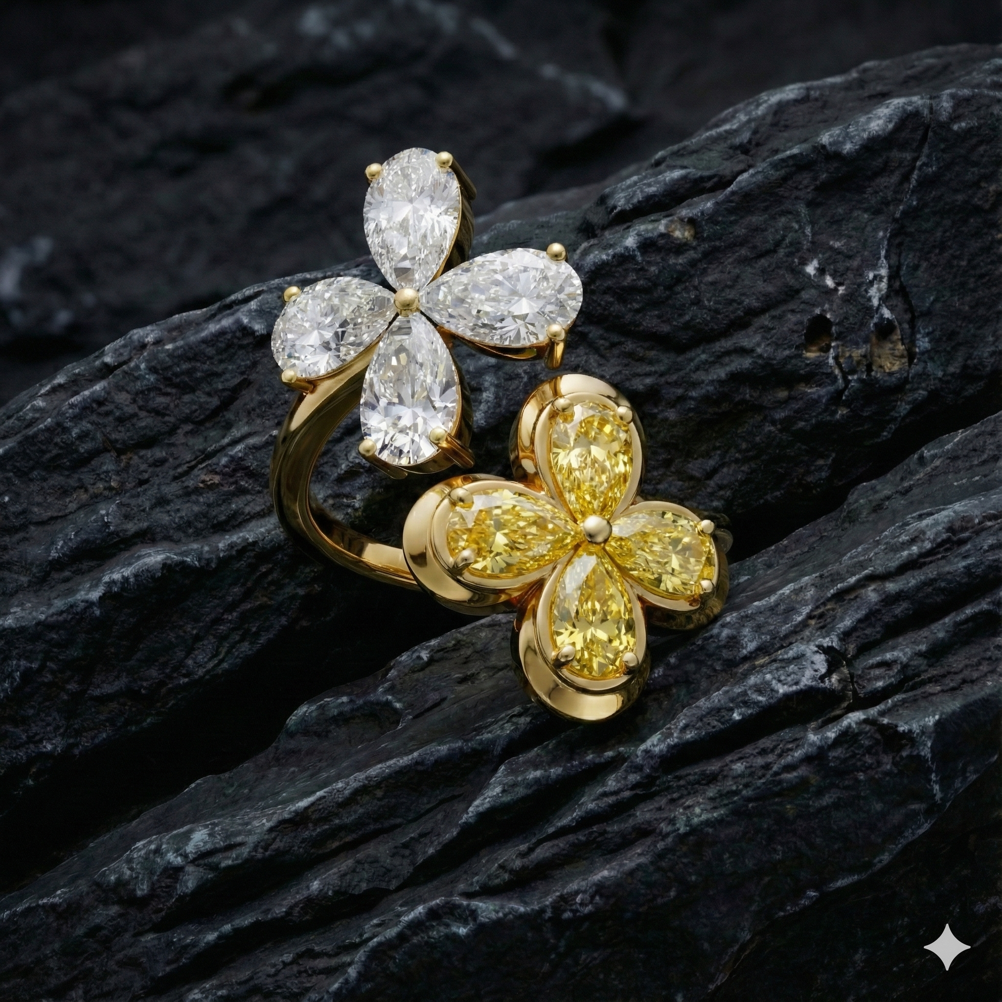 Yellow gold floral diamond ring resting on a textured dark rock, highlighting the organic flower silhouette, marquise-cut diamond sparkle, and contrast between polished gold and rugged natural stone.