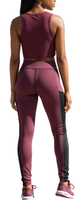 Woman wearing high-rise color block leggings with black slimming panels, maroon accents, and side pockets, standing in a sporty pose.