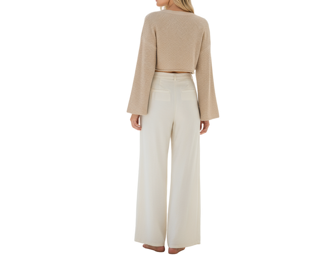 Linen-blend wide-leg pants in cream with visible twill texture and relaxed drape.