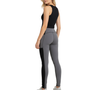 Woman wearing high-rise color block leggings with black slimming panels, grey  accents, and side pockets, standing in a sporty pose.
